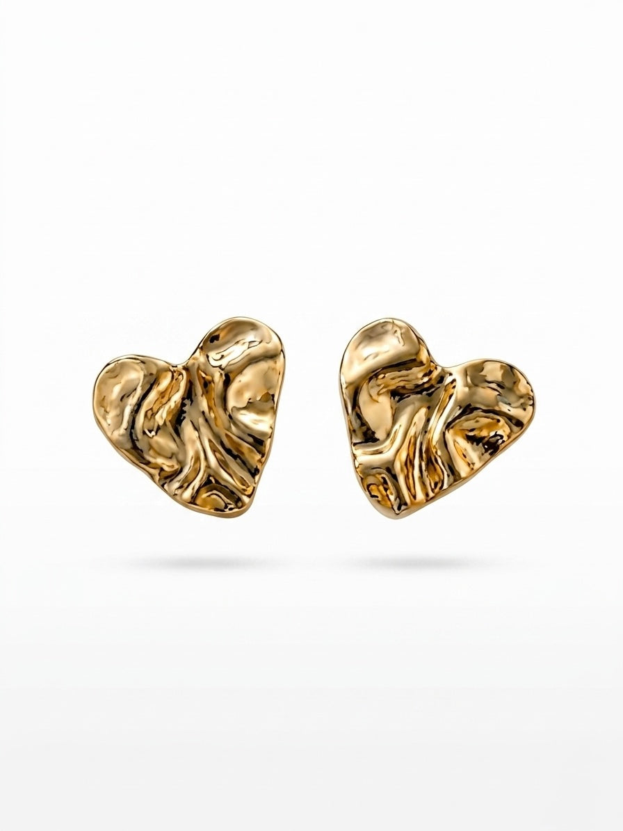 Chic crumpled gold heart statement studs.