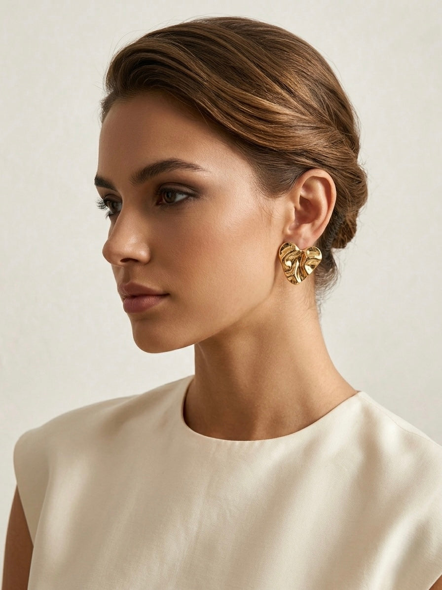Chic crumpled gold heart statement studs.