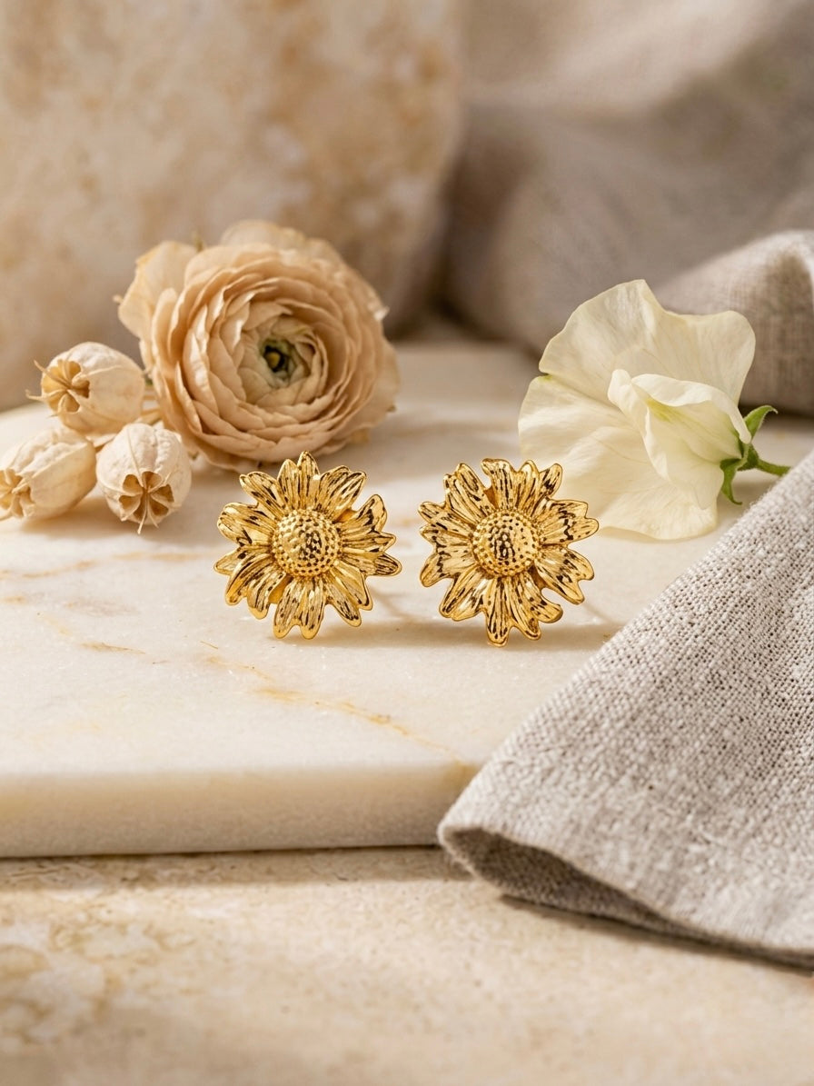 Intricate textured gold sunflower stud earrings.