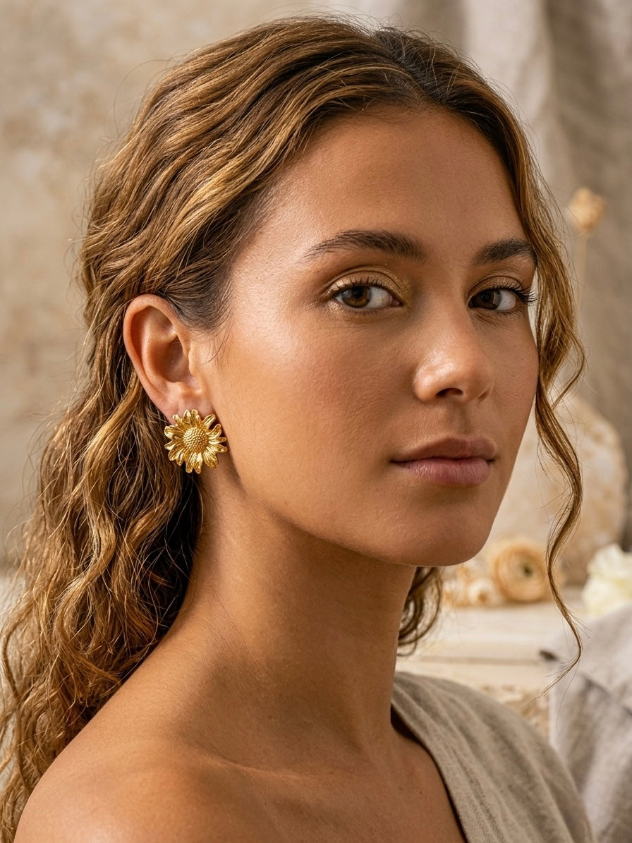 Intricate textured gold sunflower stud earrings.