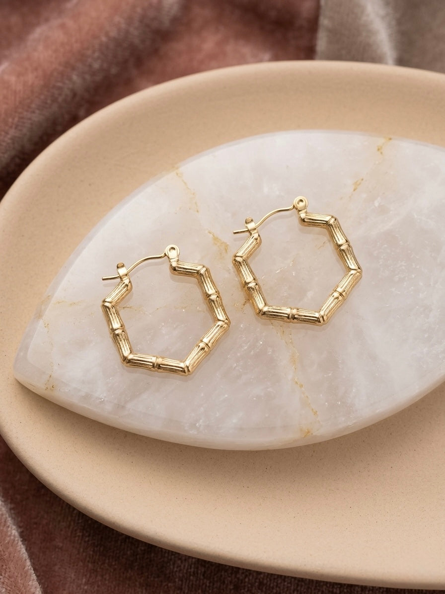Geometric gold bamboo hexagonal hoop earrings.