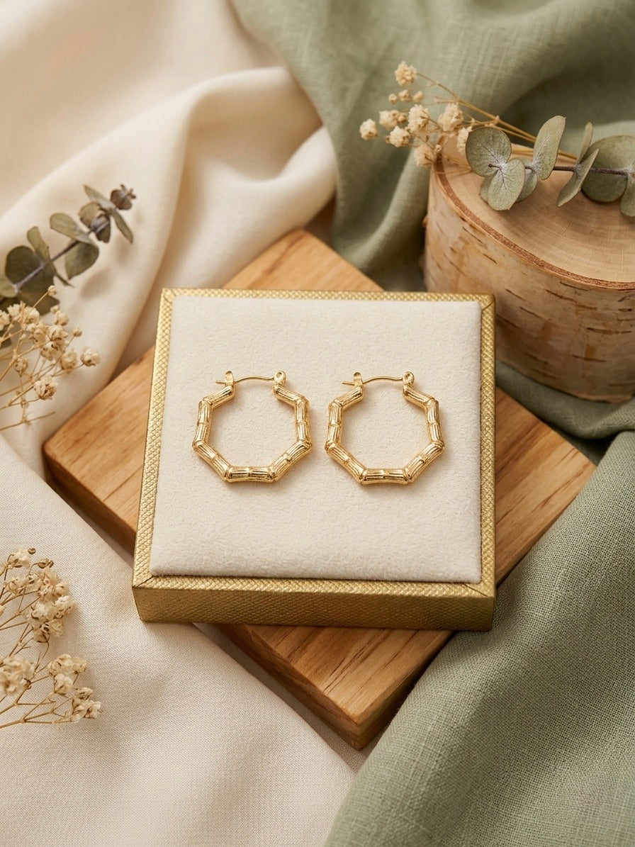 Geometric gold bamboo hexagonal hoop earrings.