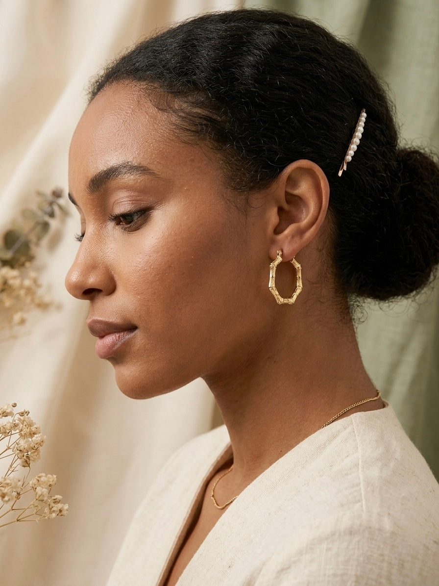 Geometric gold bamboo hexagonal hoop earrings.