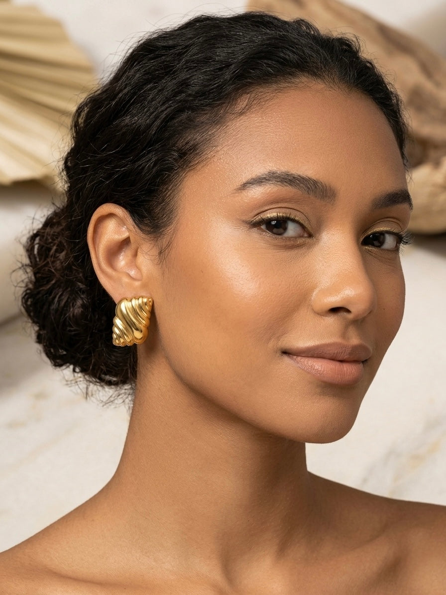 Elegant sculptural textured gold earring studs.