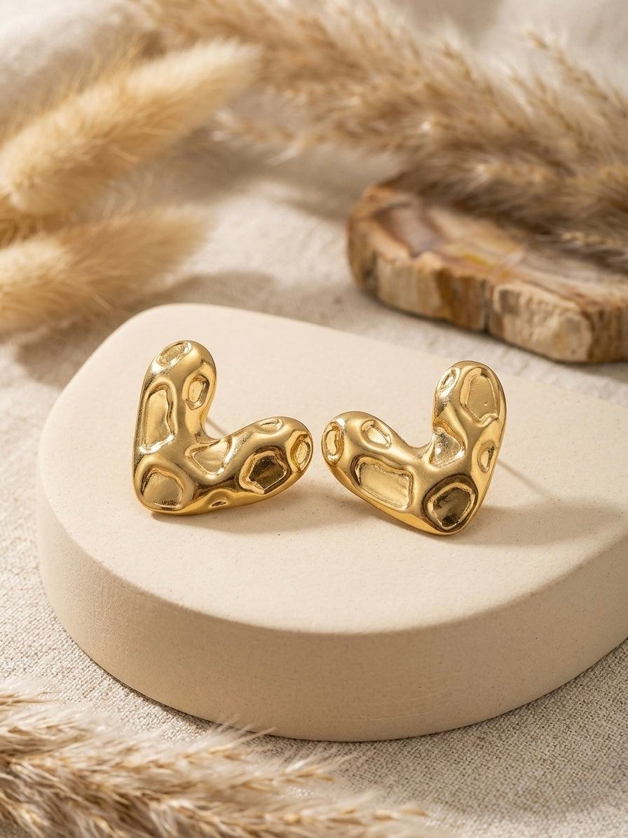 Abstract textured molten gold heart studs.