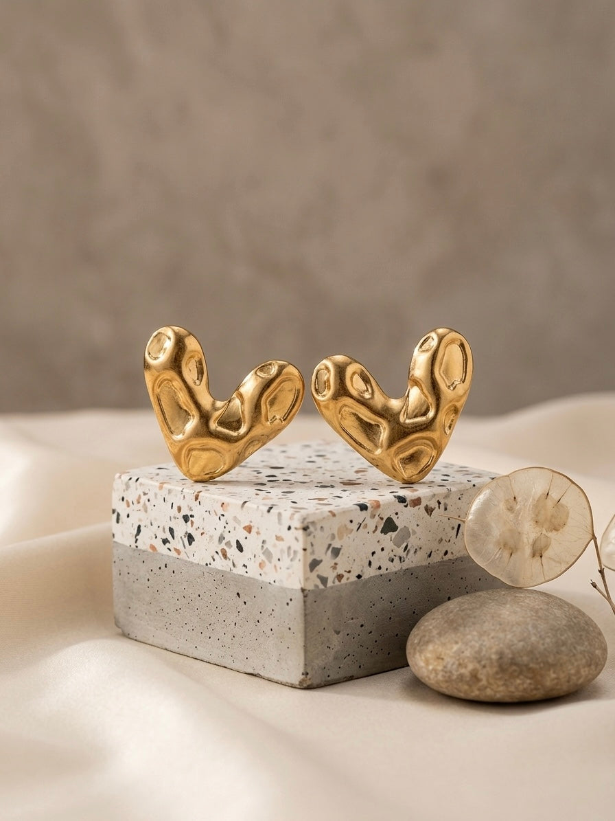 Abstract textured molten gold heart studs.