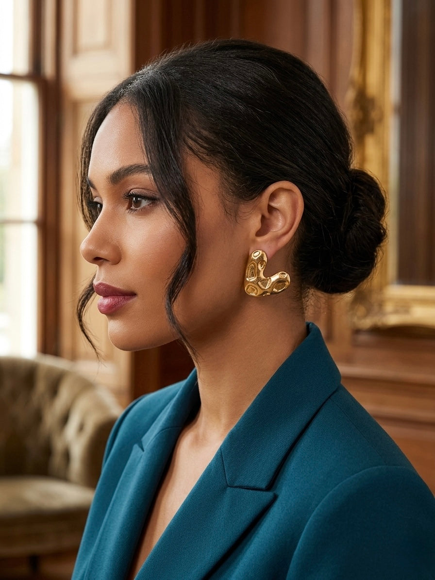 Abstract textured molten gold heart studs.