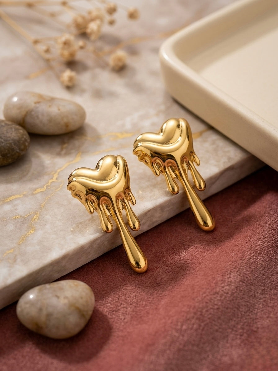 Dripping molten gold heart stud earrings.