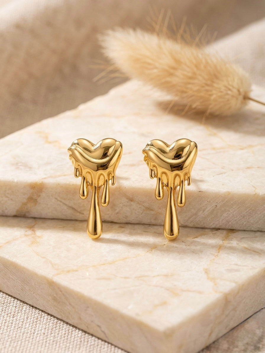 Dripping molten gold heart stud earrings.