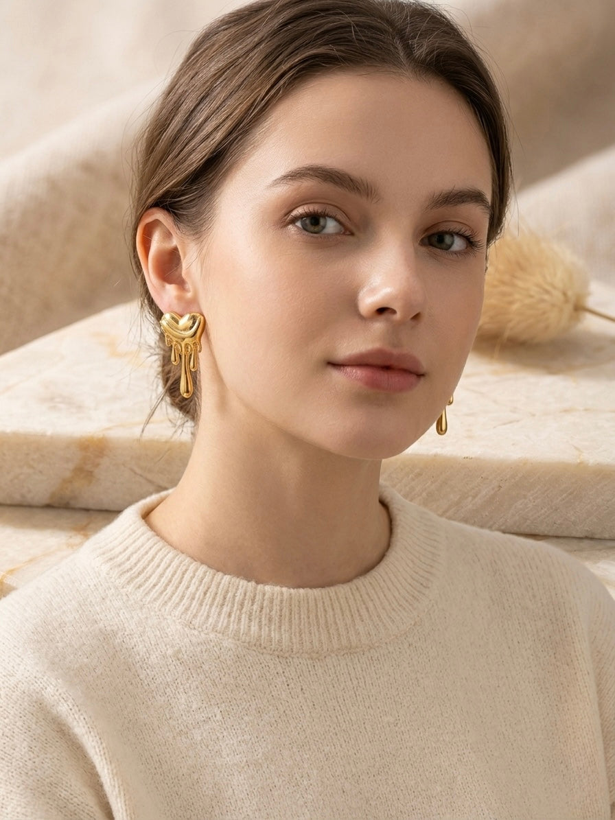 Dripping molten gold heart stud earrings.