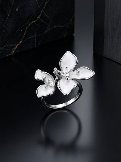 Silver flower ring showing white enamel petal detail