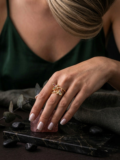 Vibrant gold bypass multicolor gemstone ring.