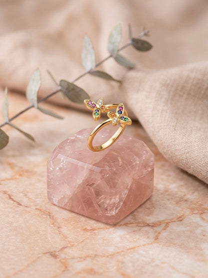 Vibrant gold bypass multicolor gemstone ring.