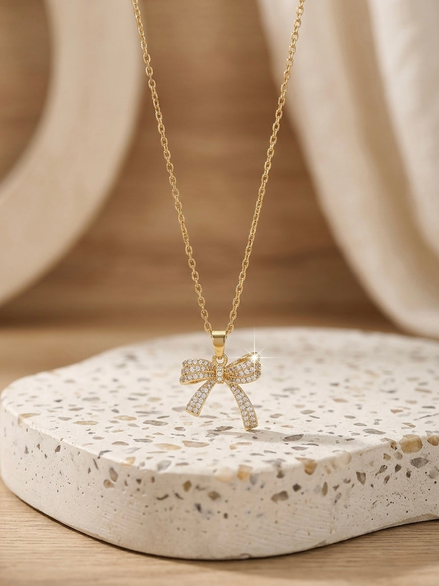 Charming gold bow pendant diamond necklace.