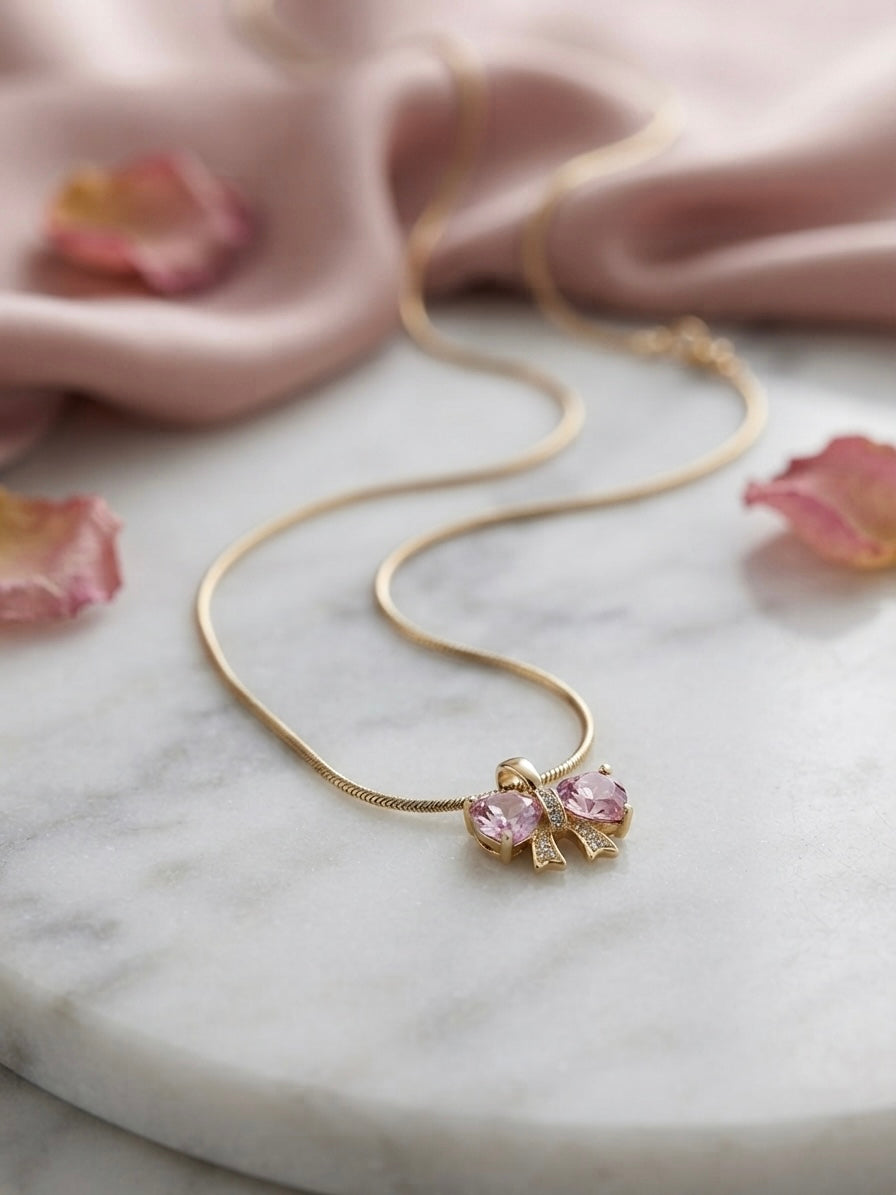 Elegant gold bow heart necklace.