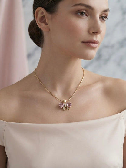 Elegant gold bow heart necklace.