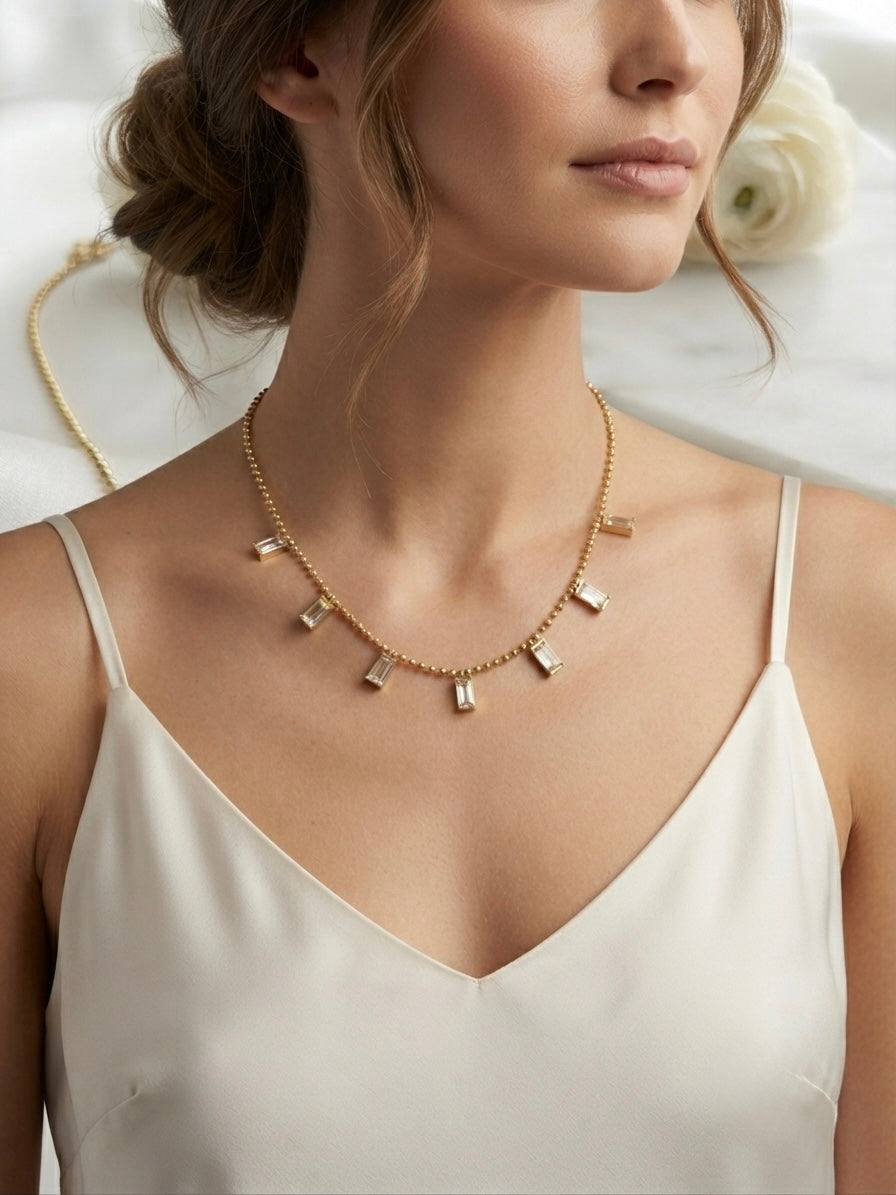 Radiant gold baguette charm necklace.