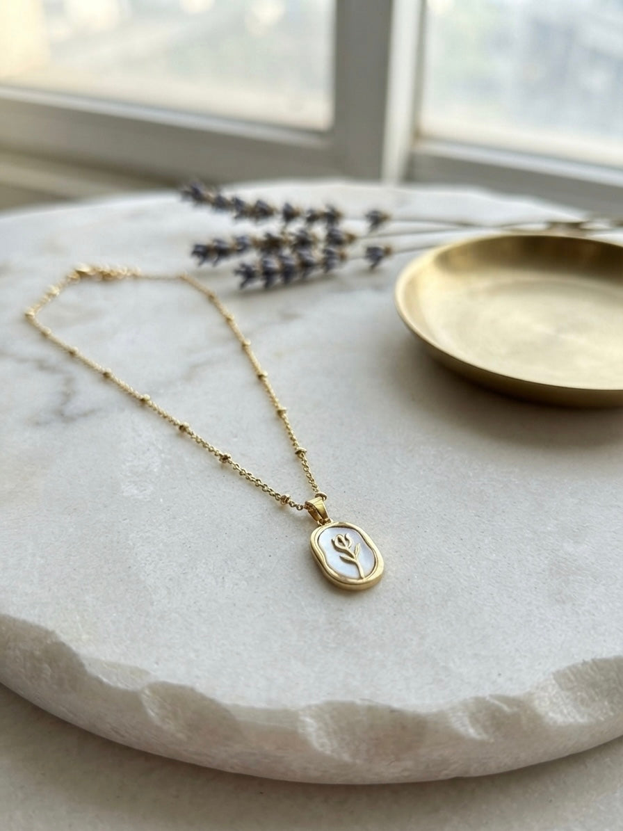 Elegant gold tulip pendant necklace.