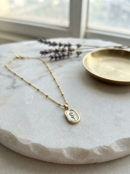 Elegant gold tulip pendant necklace.