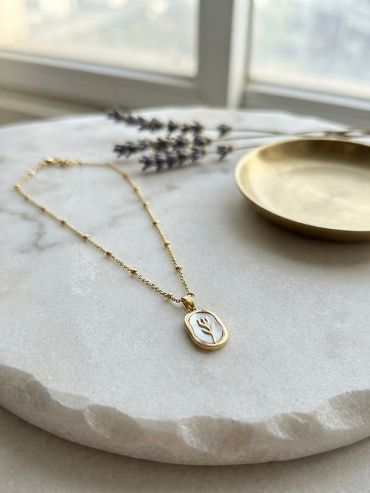 Elegant gold tulip pendant necklace.