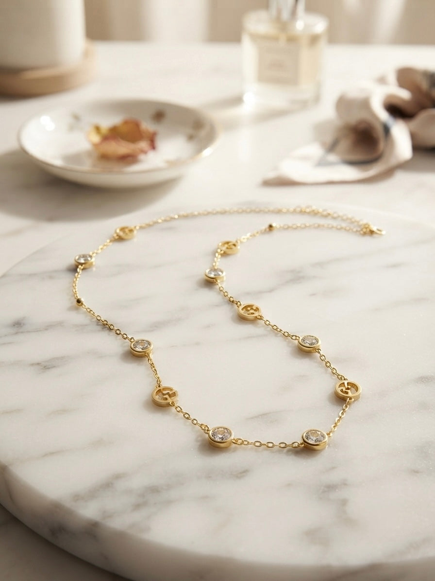 Elegant gold logo charm necklace.