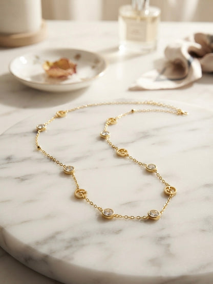 Elegant gold logo charm necklace.