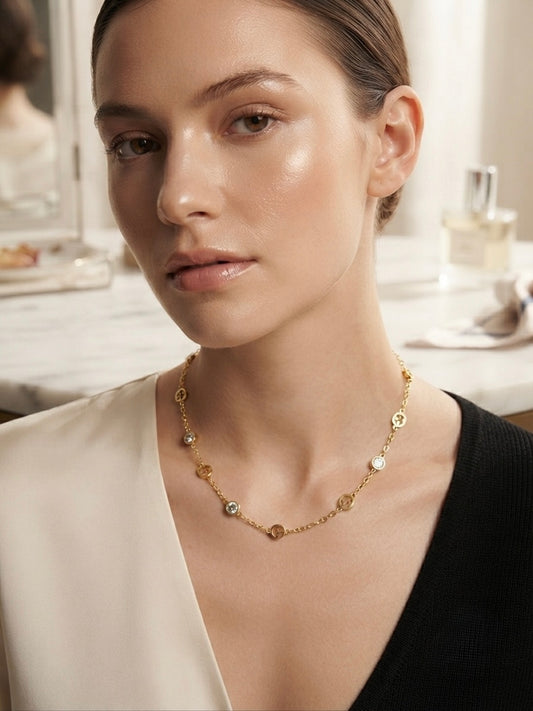 Elegant gold logo charm necklace.