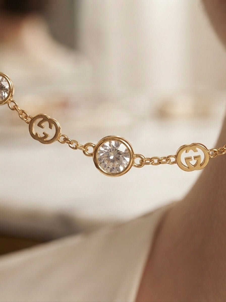 Elegant gold logo charm necklace.
