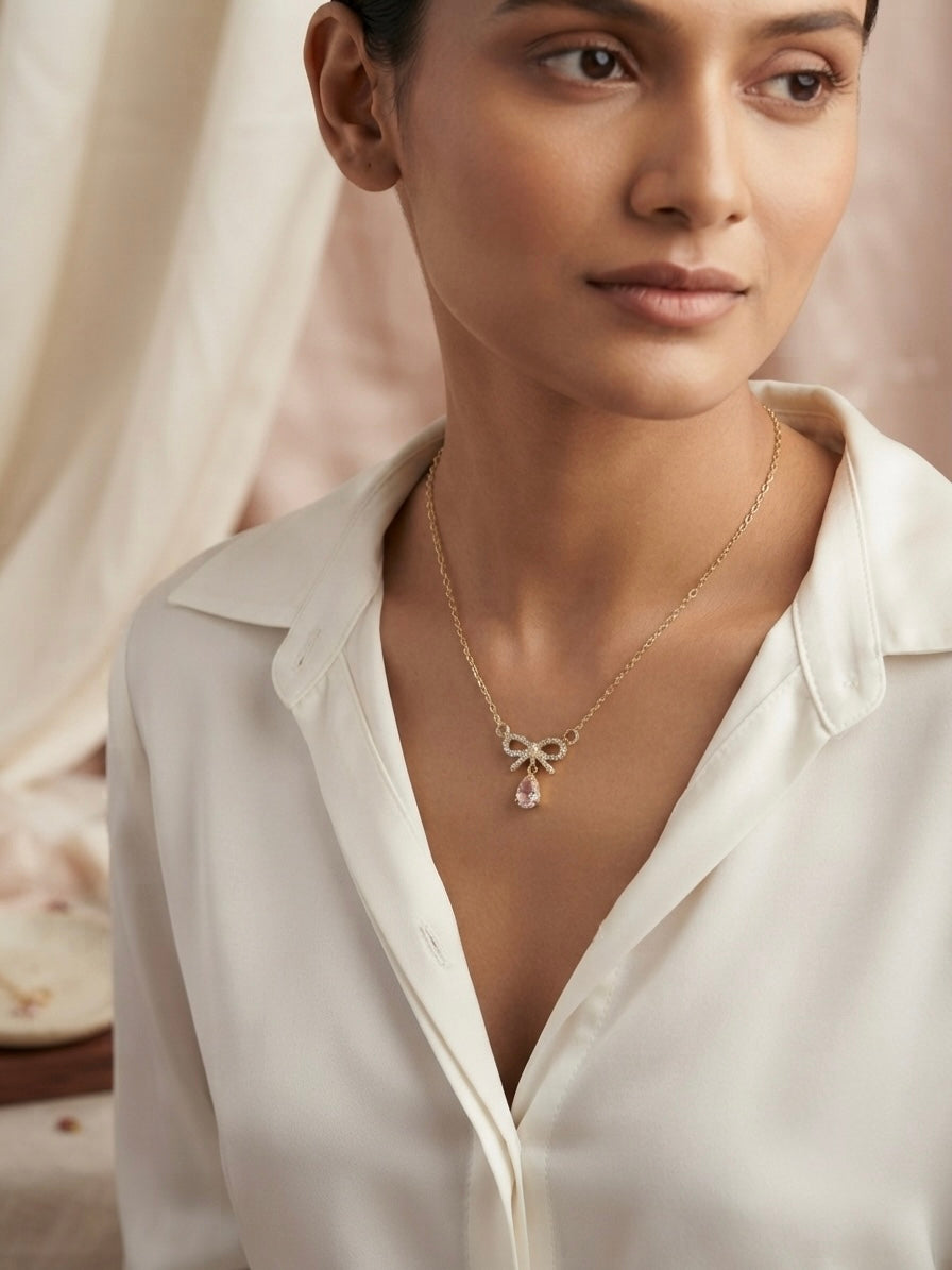 Charming gold bow pendant necklace.