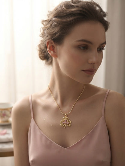 Elegant gold clover charm necklace.