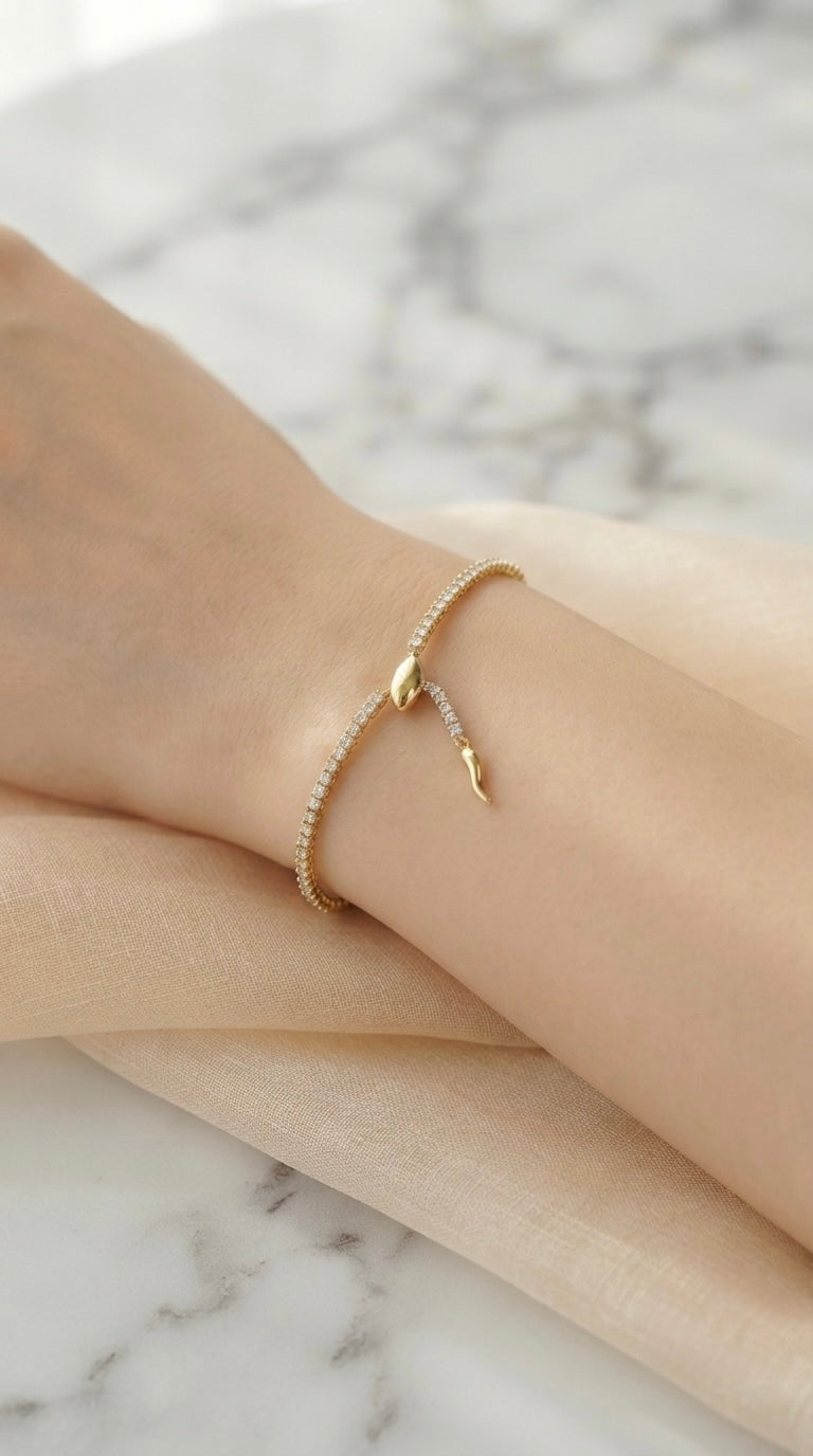 Sleek gold snake adjustable tennis bracelet.