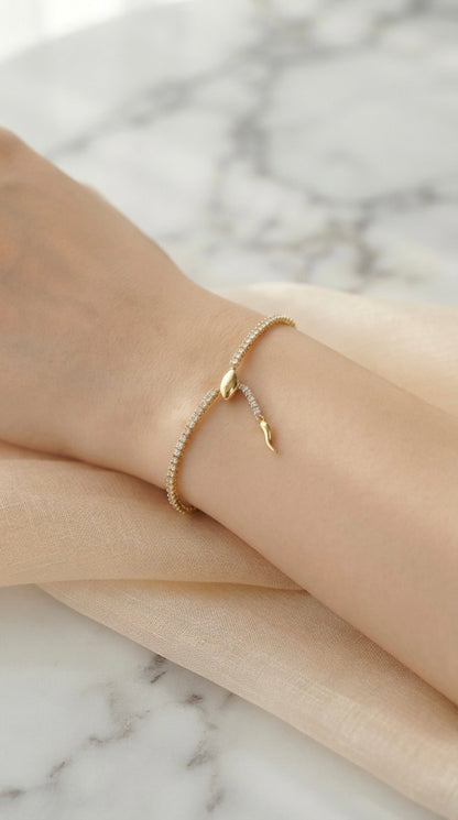Sleek gold snake adjustable tennis bracelet.