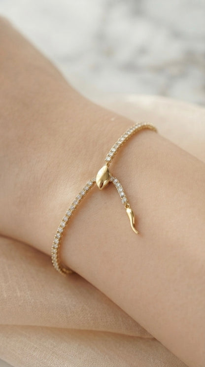 Sleek gold snake adjustable tennis bracelet.