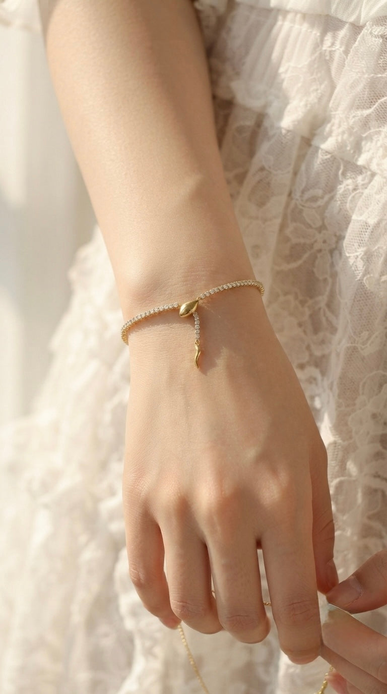 Sleek gold snake adjustable tennis bracelet.