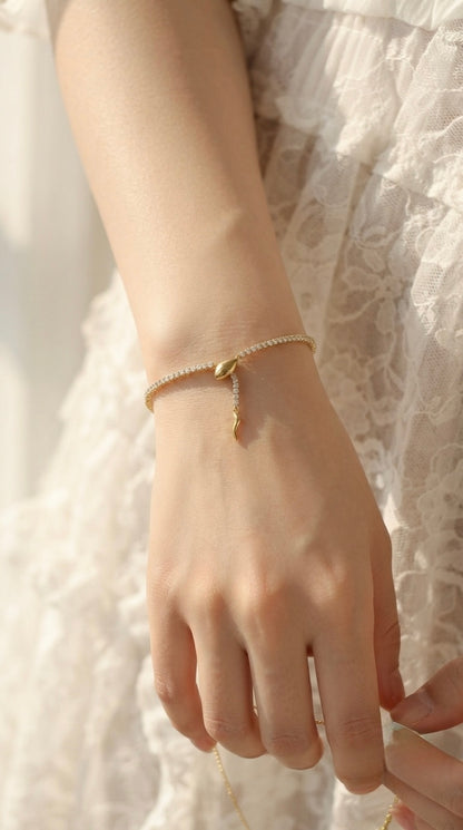 Sleek gold snake adjustable tennis bracelet.