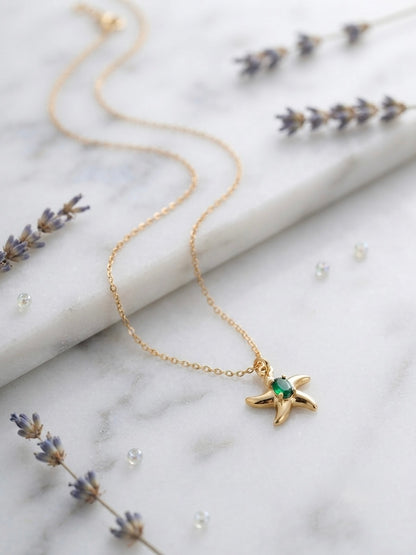 Shimmering green stone, durable gold starfish.