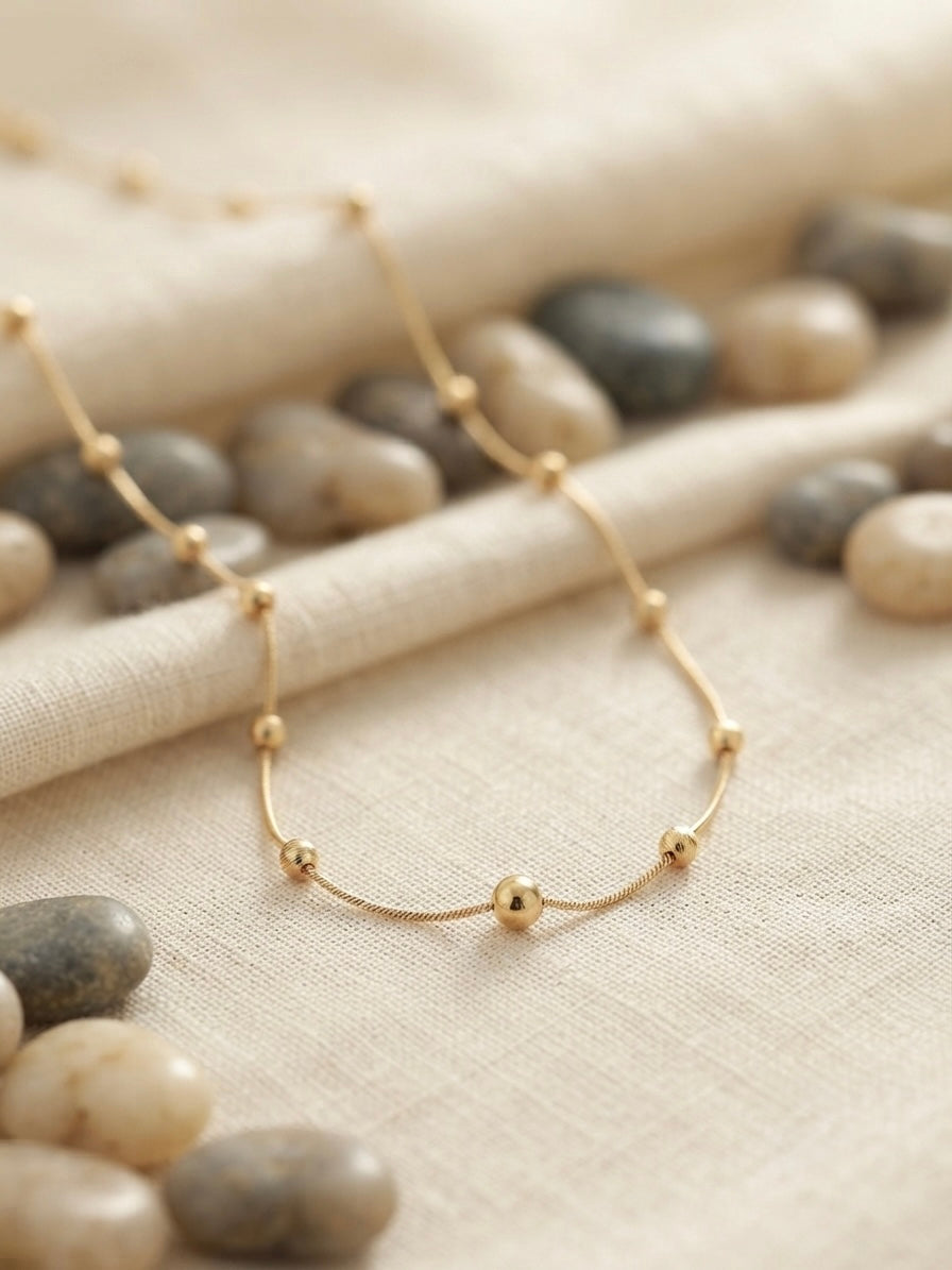 Minimalist gold beads, timeless refined style.