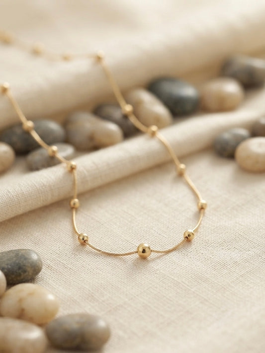 Minimalist gold beads, timeless refined style.