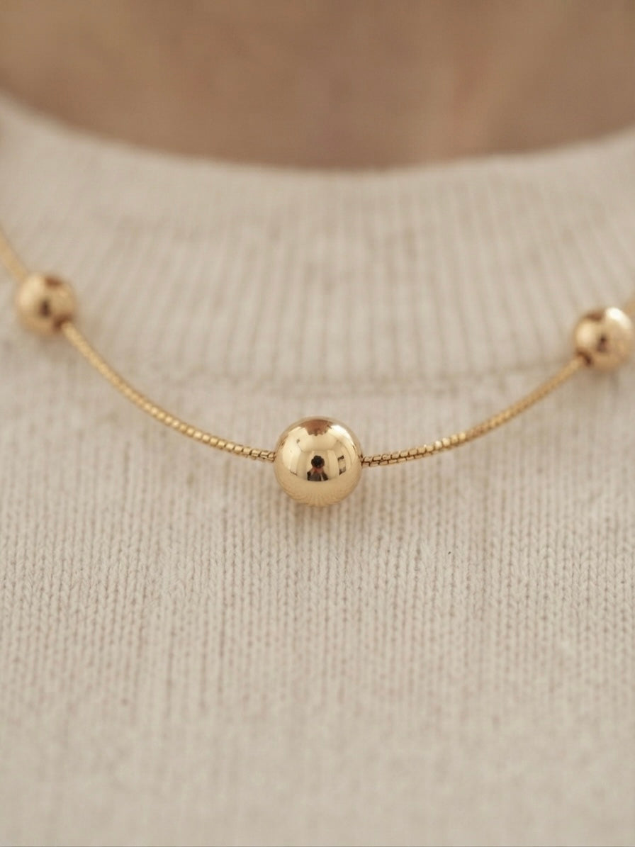 Minimalist gold beads, timeless refined style.