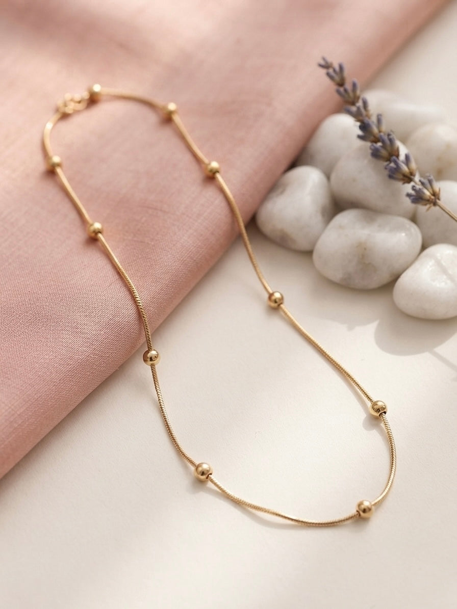 Minimalist gold beads, timeless refined style.