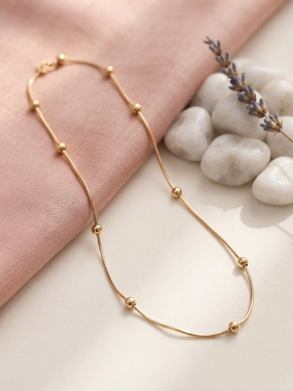 Minimalist gold beads, timeless refined style.