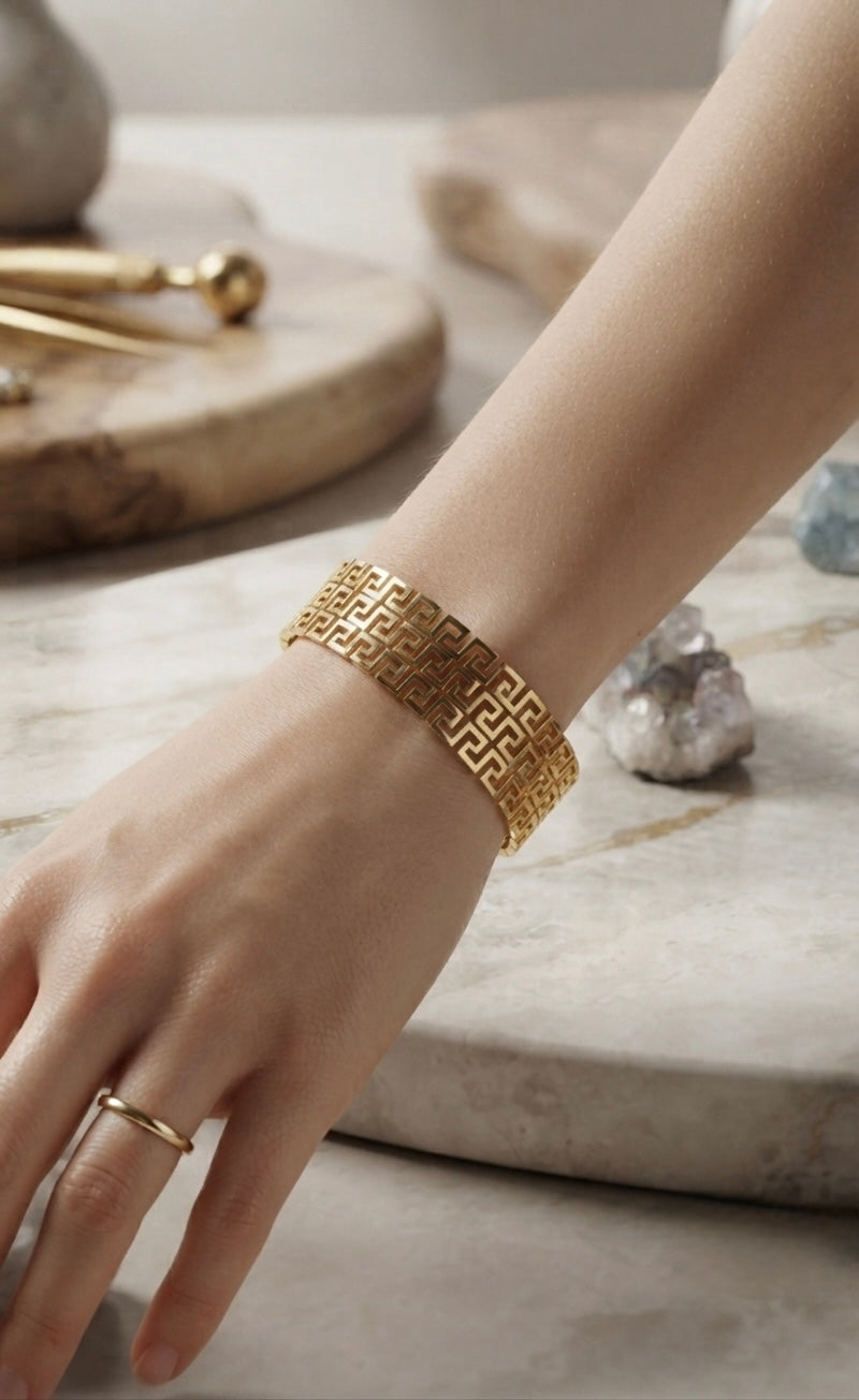Elegant gold Greek-pattern Kada bracelet.