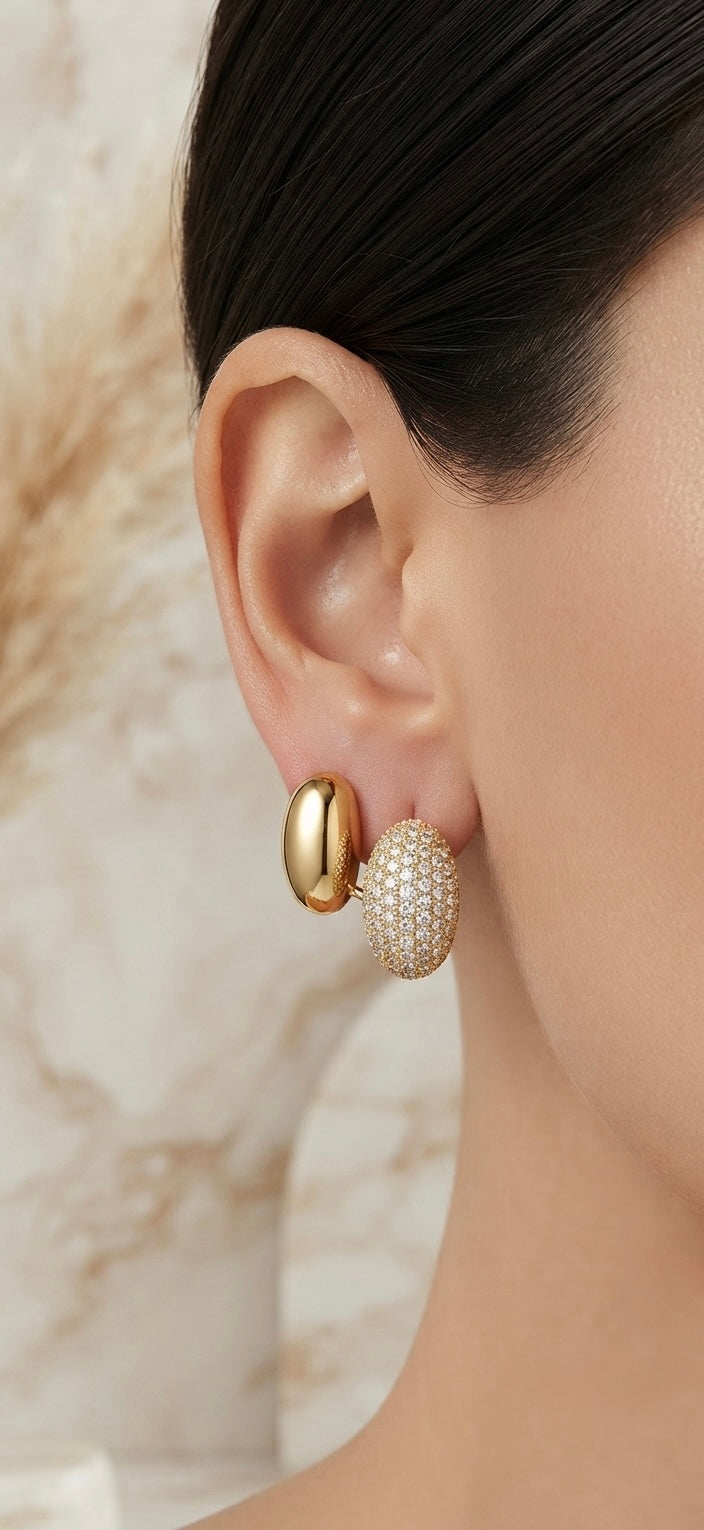 Elegant gold stud, dazzling crystal accent.