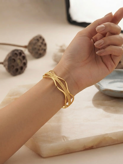 Elegant wavy gold statement bracelet.