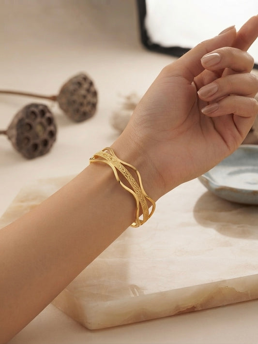 Elegant wavy gold statement bracelet.