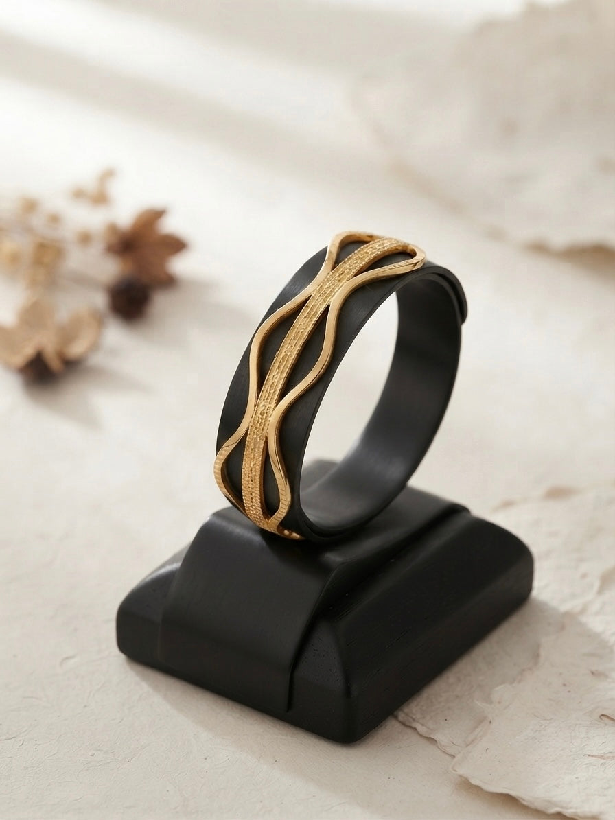 Elegant wavy gold statement bracelet.