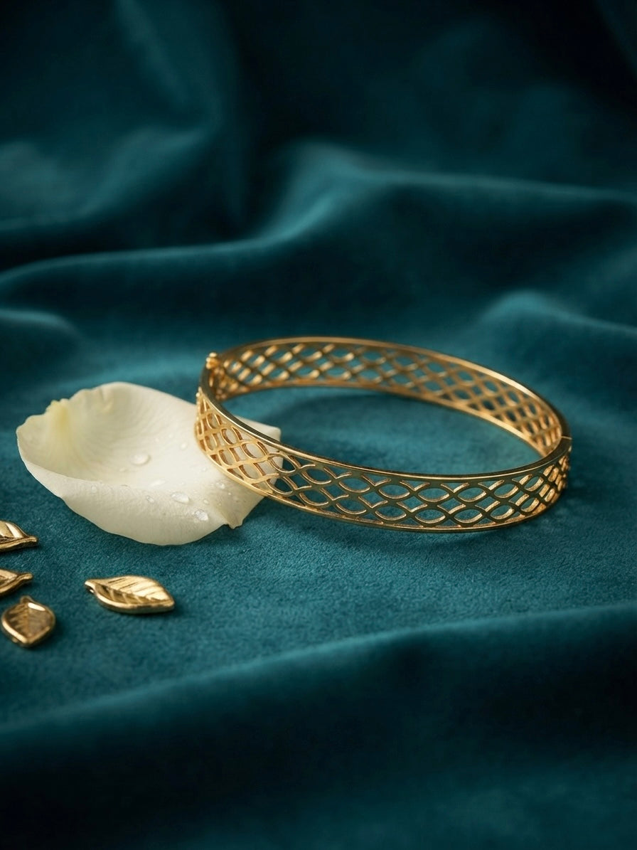 Modern interlocking gold geometric bangle.