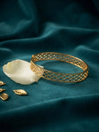 Modern interlocking gold geometric bangle.