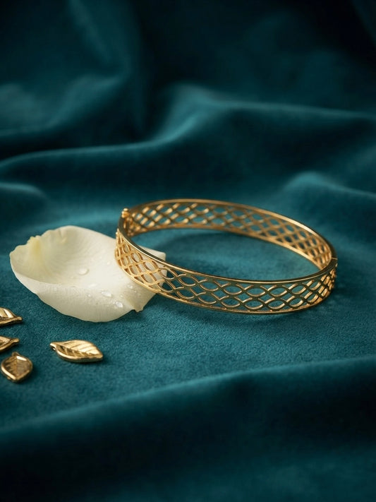 Modern interlocking gold geometric bangle.