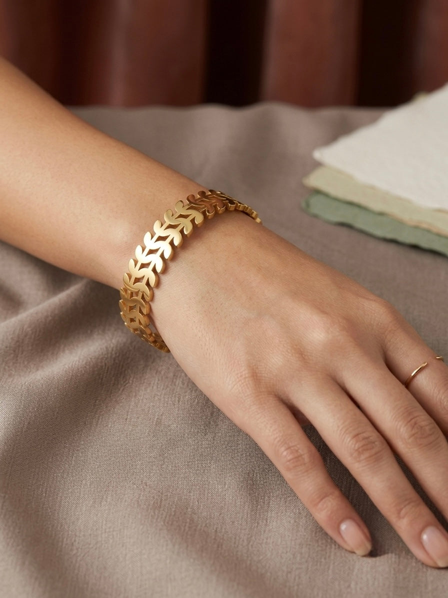 Nature-inspired polished gold leaf cuff.